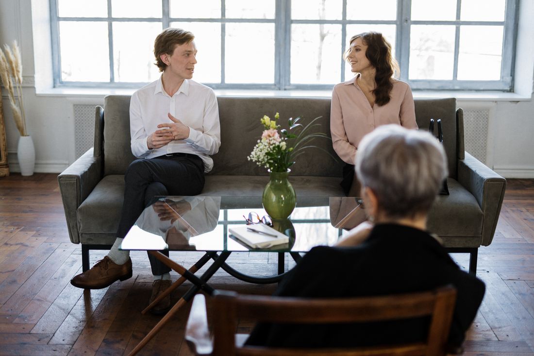 Three people talking in a living room
